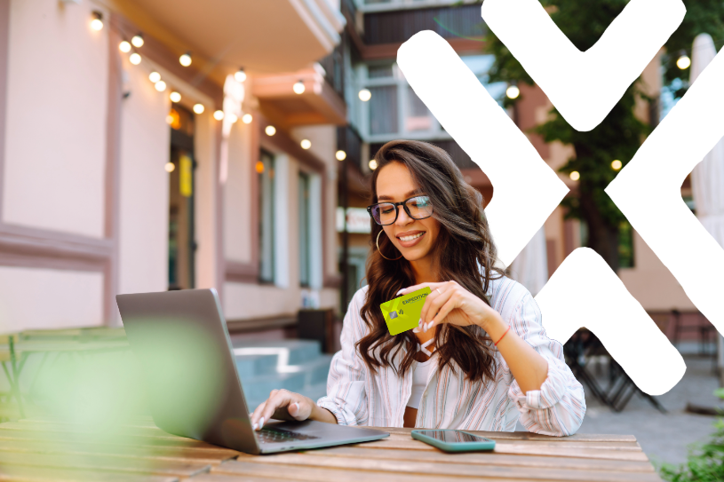Woman holding card on computer