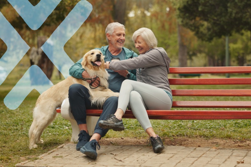 older couple on bench with dog