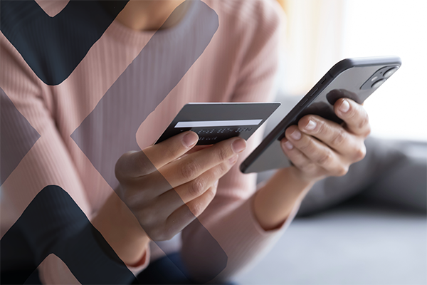 woman using phone and card